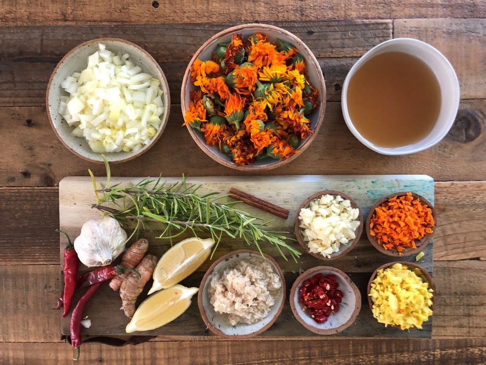 Fire Cider Ingredients of Apple Cider Vinegar, Calendula, Onions, Garlic, Ginger, Turmeric, Cinnamon, Cayenne, Rosemary, Horseradish, Lemon and Honey