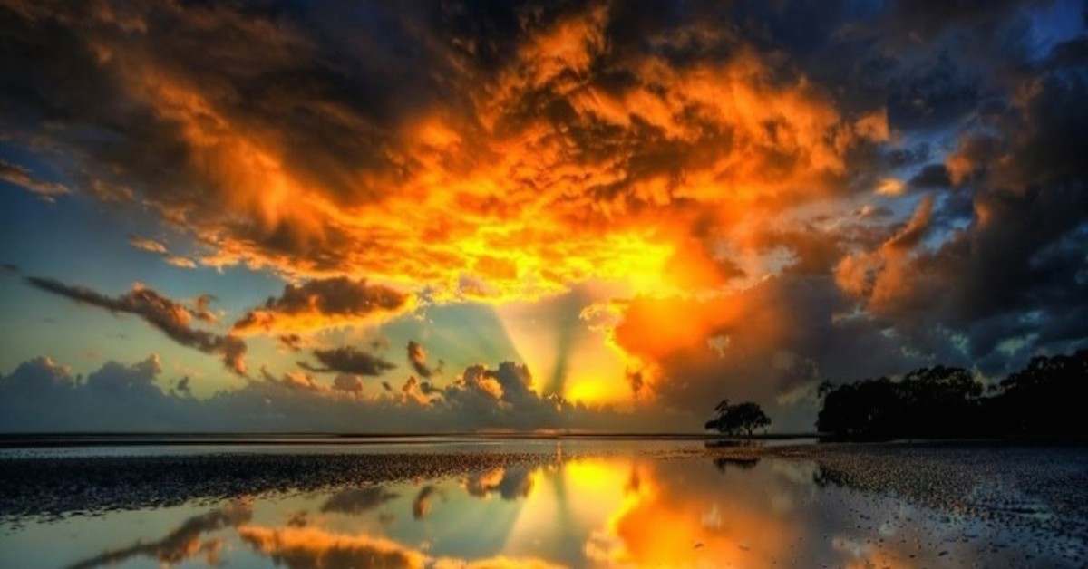 Golden Sun and Orange Clouds Reflecting on the Water