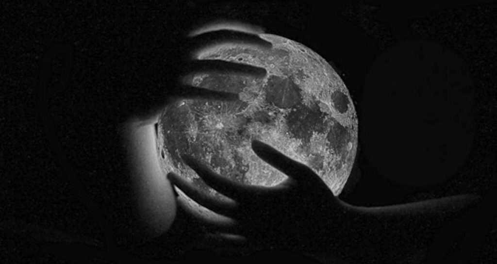 Hands Caressing a Glowing Moon