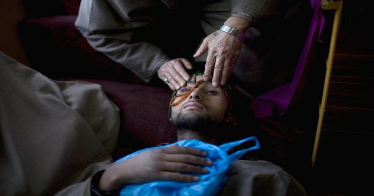 A Folk Healer Places His Hands and a Mala on a Patient's Forehead