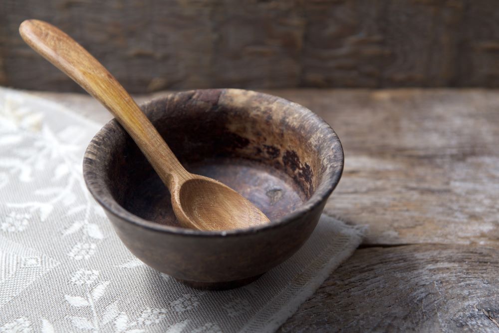 Empty Wooden Bowl with a Wooden Spoon