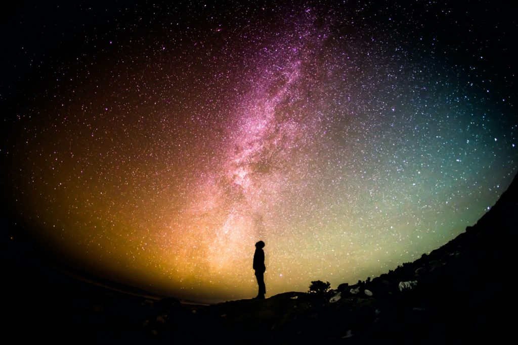 Man staring into starry sky