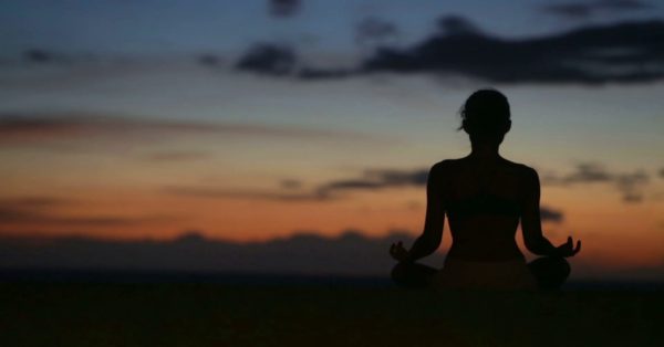 Person Meditating at Sunrise