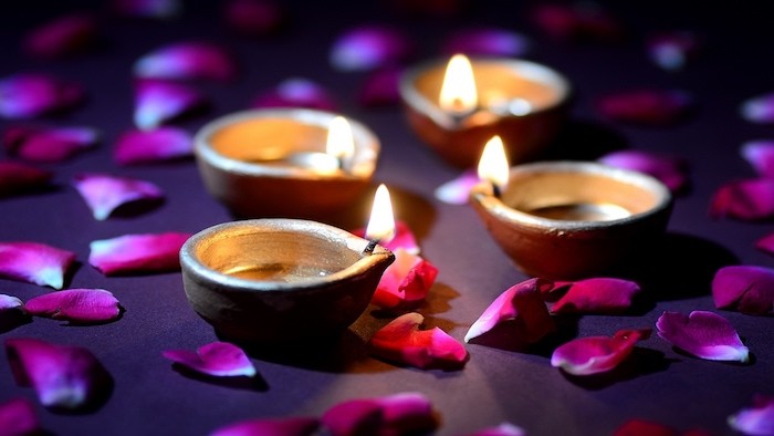 Burning Tea Lamps Surrounded by Pink Flower Petals